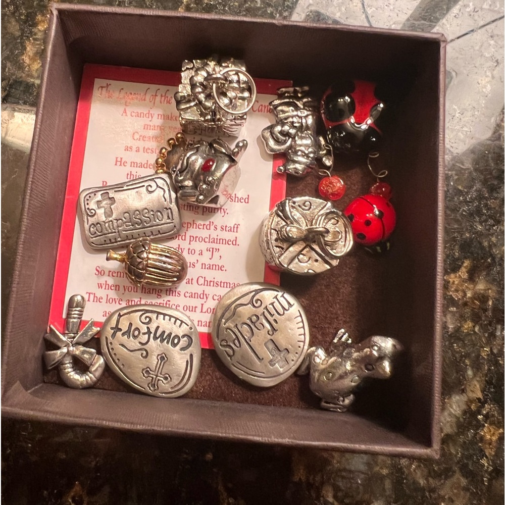 Assorted silver charms and trinkets.